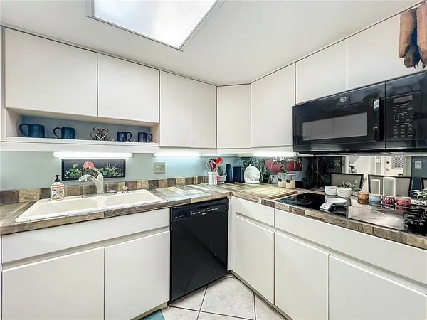 a kitchen with a sink a stove and cabinets