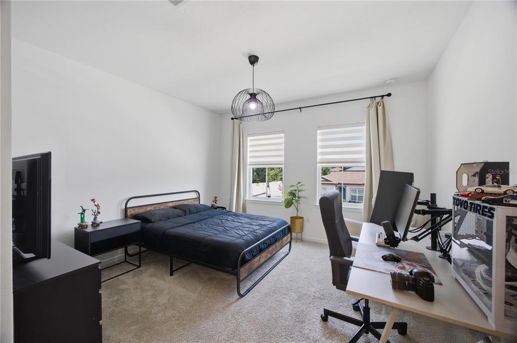 13816 Sharp Hawk Drive Riverview, FL 33569 - Photo 55 of 76 a bedroom with bed a desk and chair