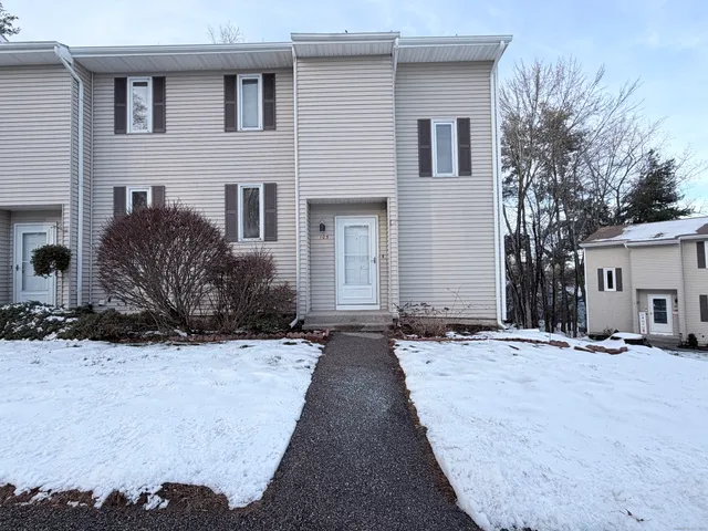 a view of a house with snow on the road