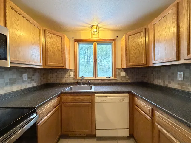 a kitchen with a sink stove and microwave