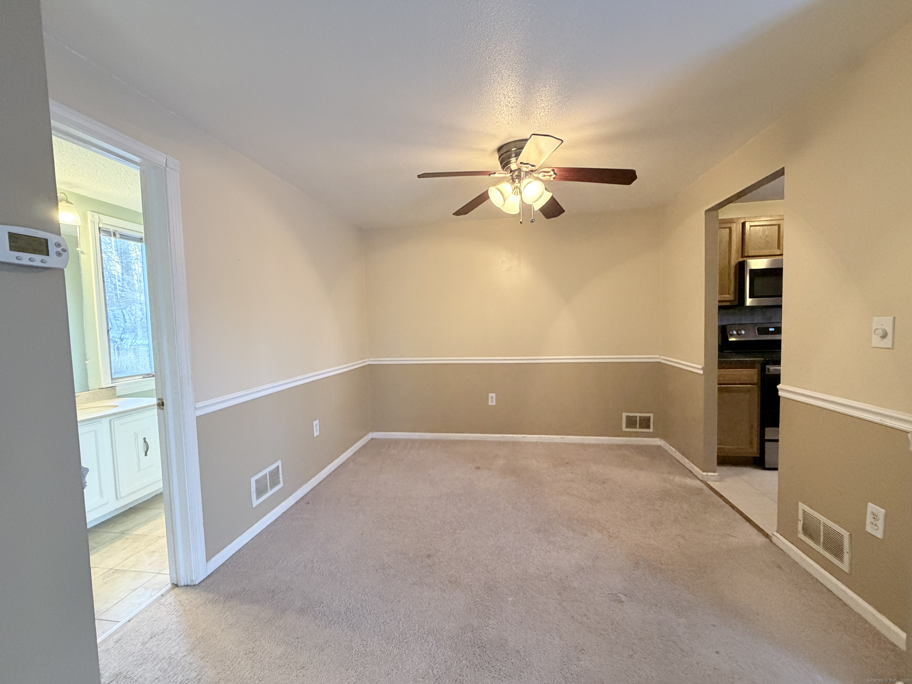 105 Spring Lane, Unit 105 Suffield, CT 06078 - Photo 4 of 16 a view of an empty room with a window