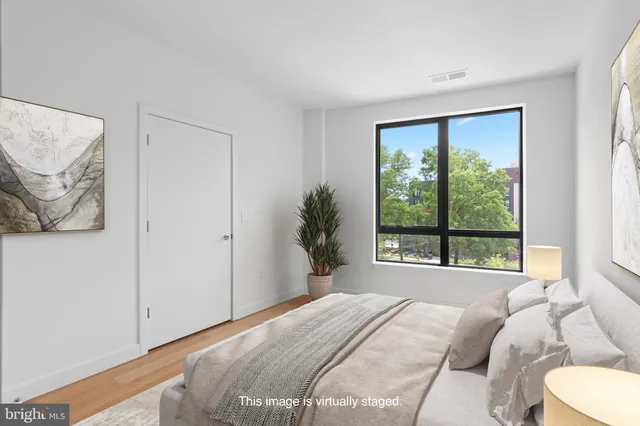 a bedroom with a large bed and a large window