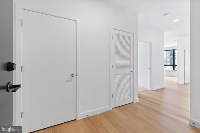 a view of a hallway with wooden floor