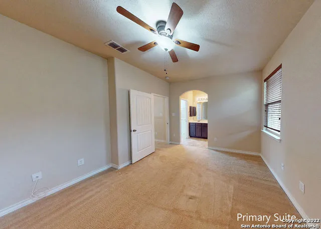 a view of a livingroom with a ceiling fan and window