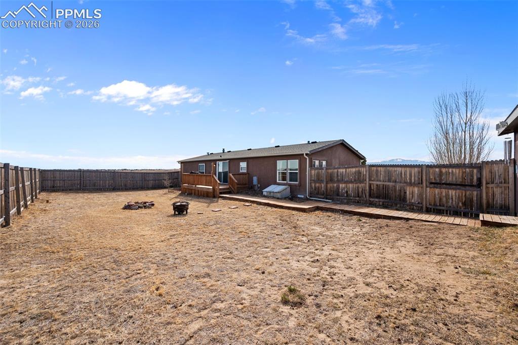 5535 Peerless Farms Road Peyton, CO 80831 - Photo 22 of 27 a swimming pool with wooden fence