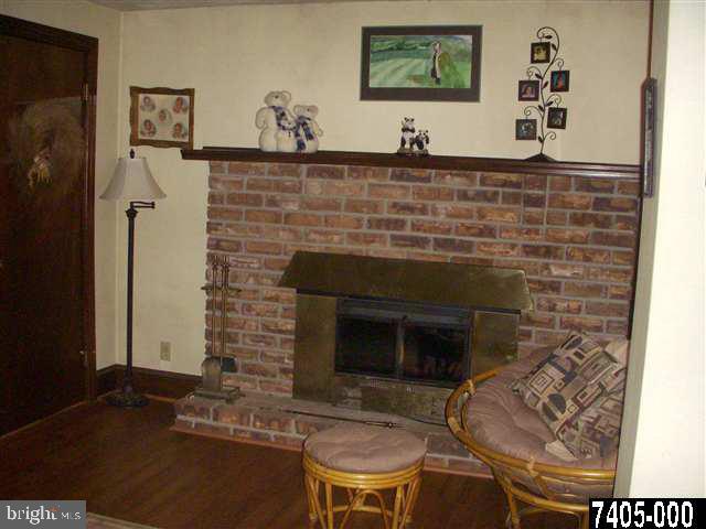 1841 Jefferson Road Spring Grove, PA 17362 - Photo 8 of 16 a fireplace with a vase and flowers on it