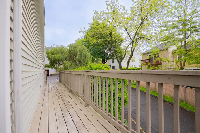 a view of a balcony with wooden floor and fence