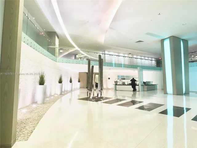 a lobby with furniture and floor to ceiling window