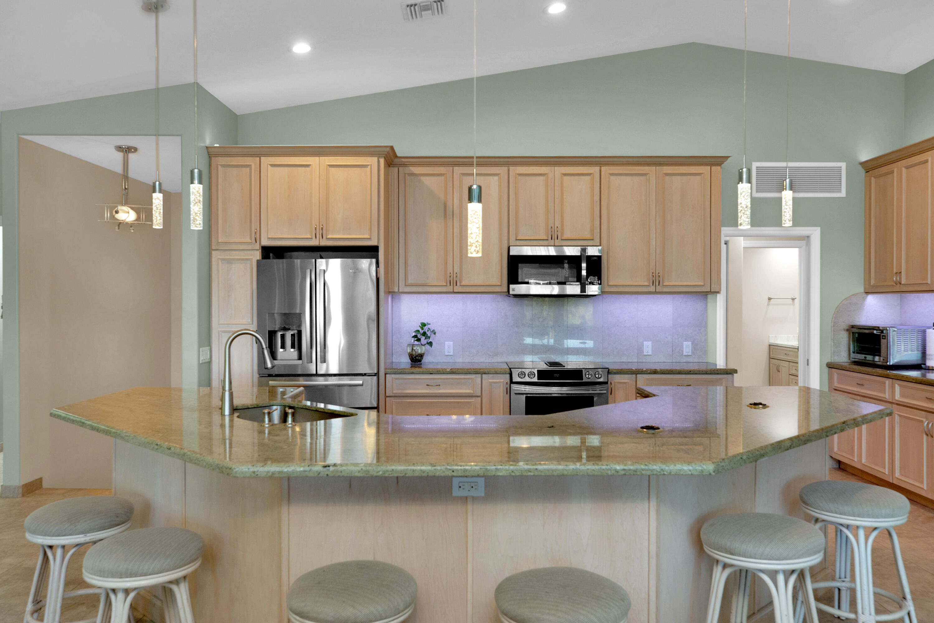 100 South Airport Road Tavernier, FL 33070 - Photo 14 of 42 a kitchen with kitchen island granite countertop a sink cabinets and stainless steel appliances
