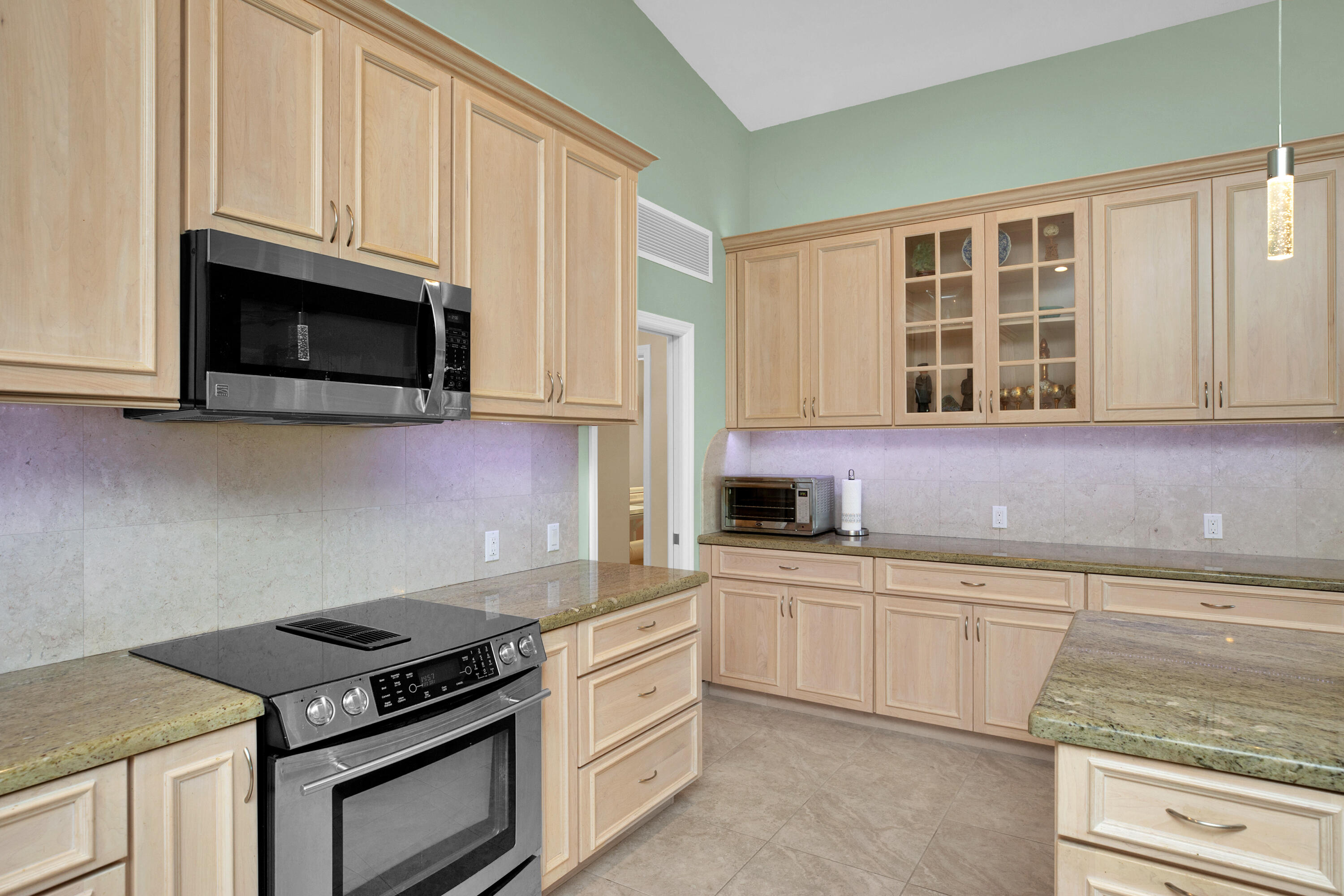 100 South Airport Road Tavernier, FL 33070 - Photo 16 of 42 a kitchen with stainless steel appliances granite countertop a stove and a microwave