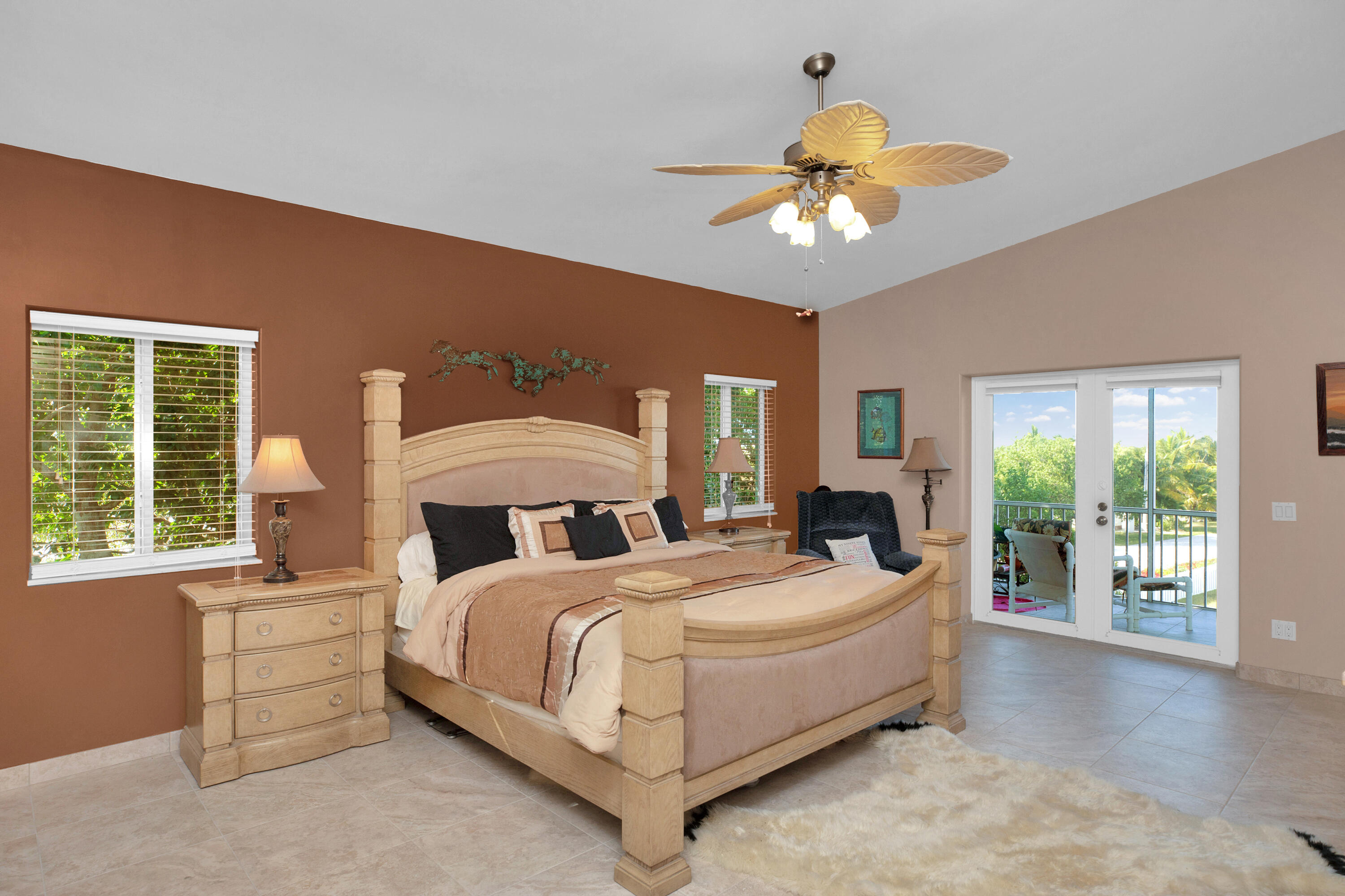 100 South Airport Road Tavernier, FL 33070 - Photo 17 of 42 a bedroom with a bed chandelier and a large window