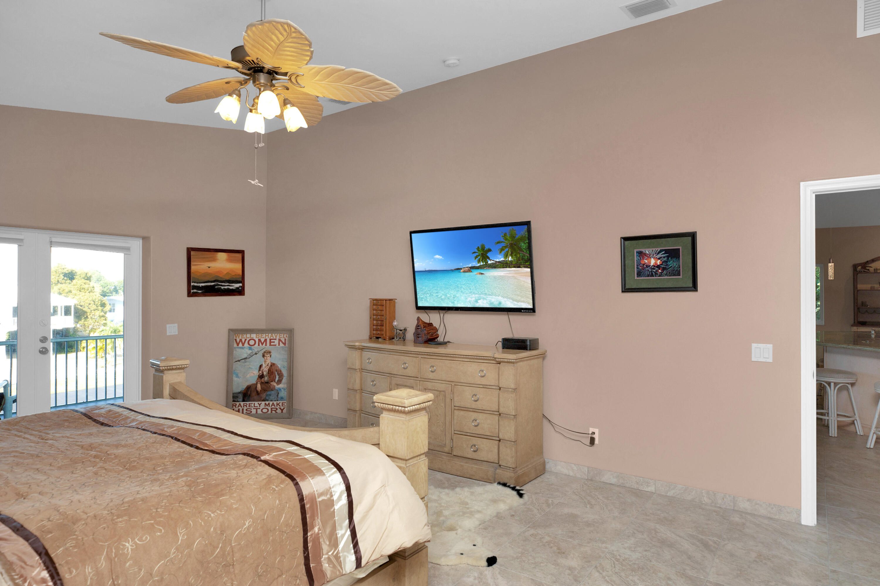 100 South Airport Road Tavernier, FL 33070 - Photo 18 of 42 a bedroom with a bed and a chandelier