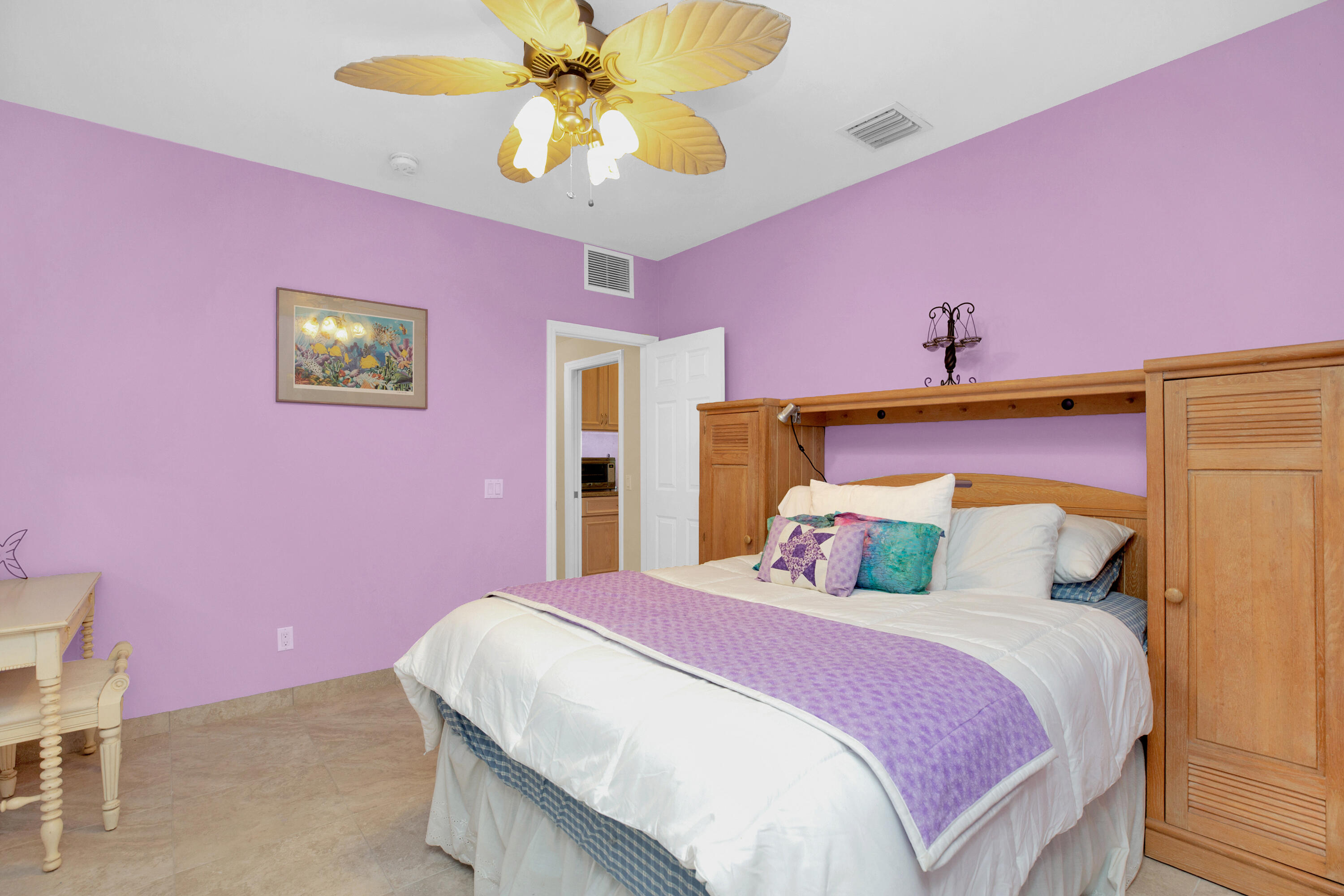 100 South Airport Road Tavernier, FL 33070 - Photo 25 of 42 a bedroom with a bed and a chandelier