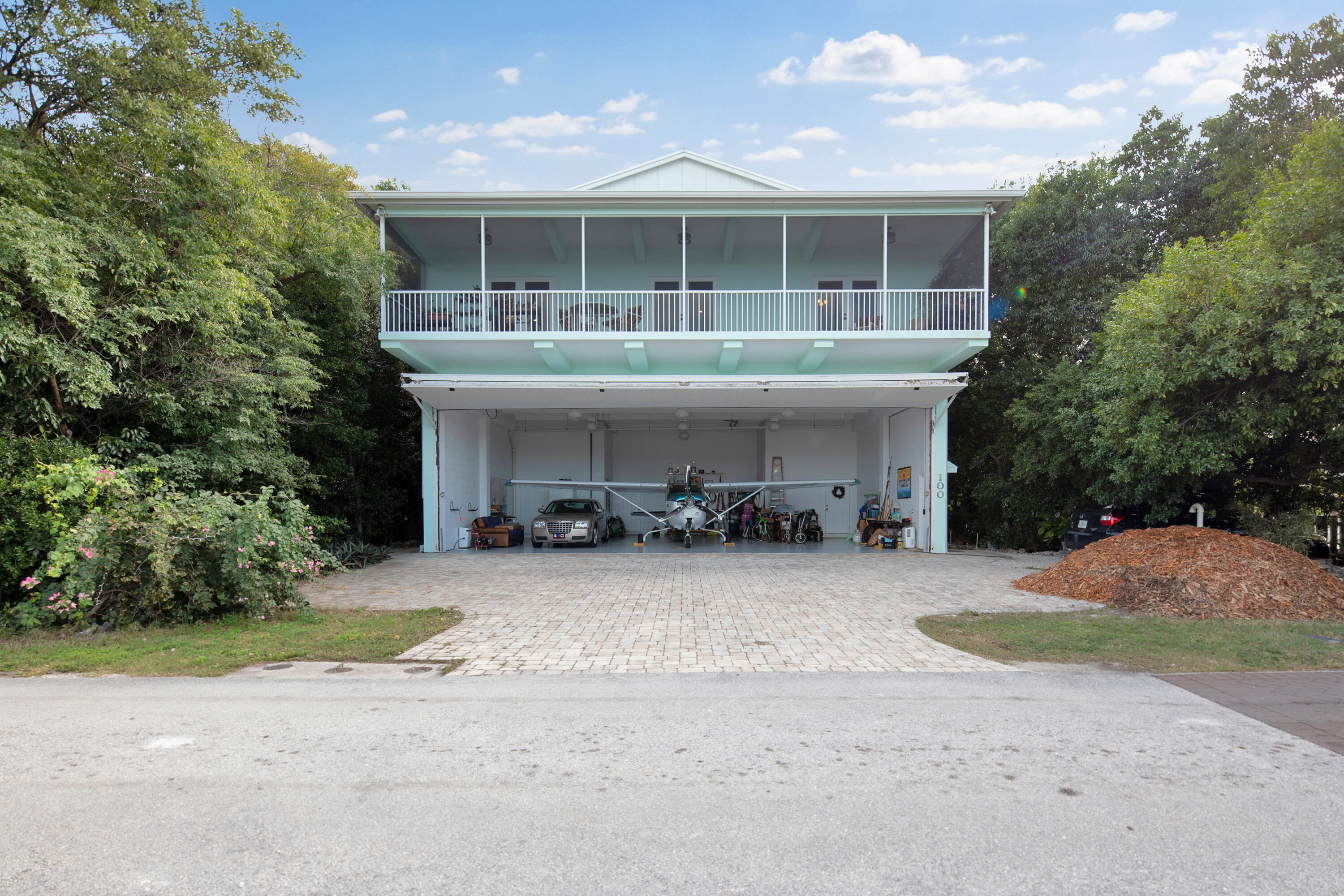 100 South Airport Road Tavernier, FL 33070 - Photo 35 of 42 a front view of a house with a yard and garage