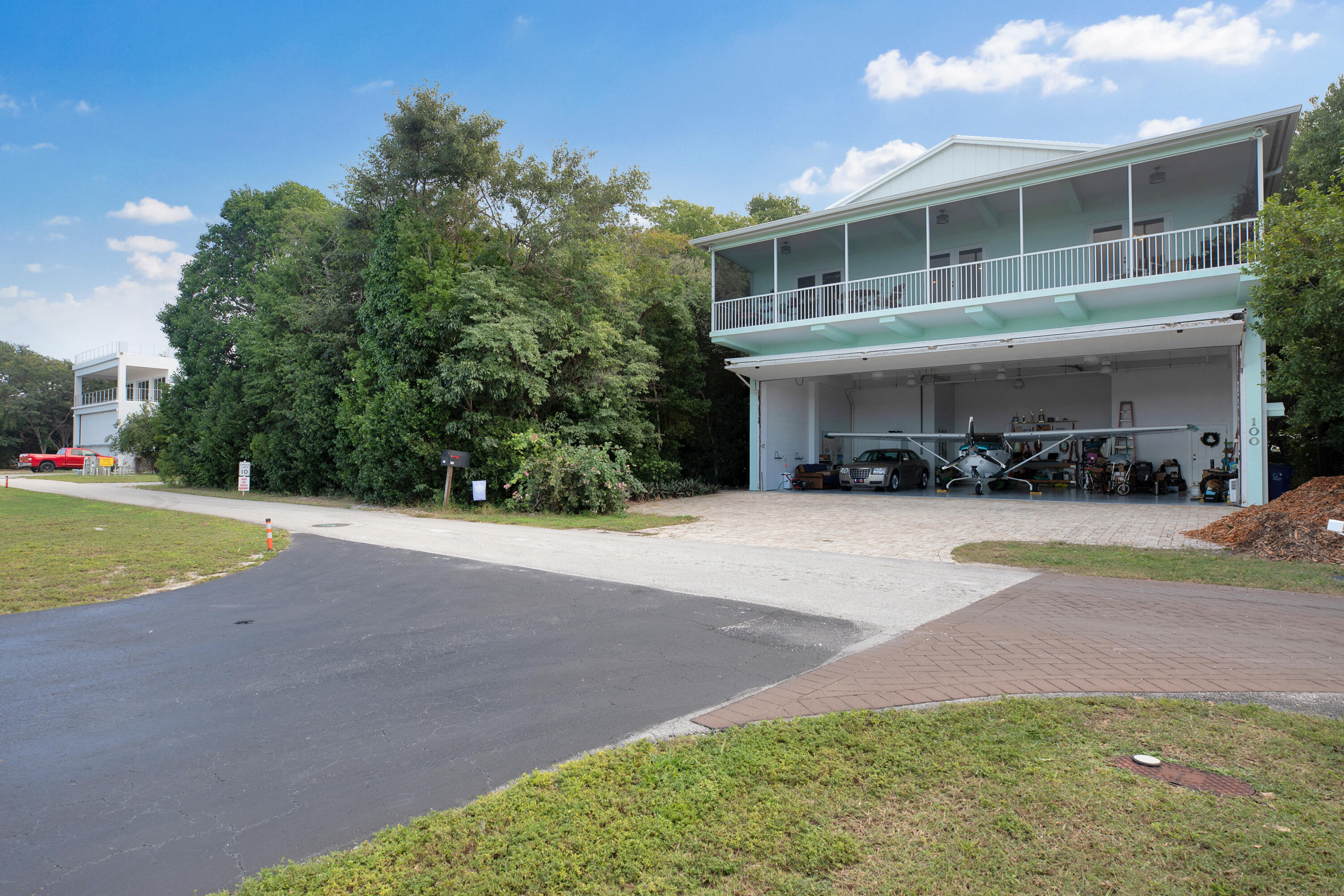100 South Airport Road Tavernier, FL 33070 - Photo 36 of 42 a front view of a house with a yard and garage