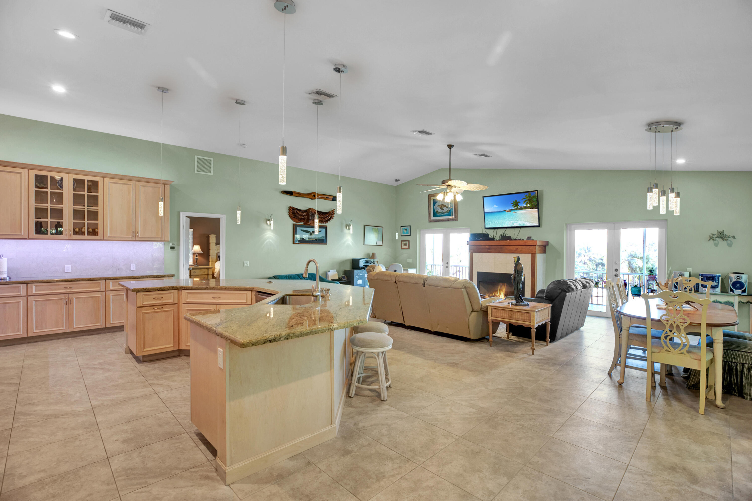 100 South Airport Road Tavernier, FL 33070 - Photo 6 of 42 a living room with furniture and a dining table with kitchen view