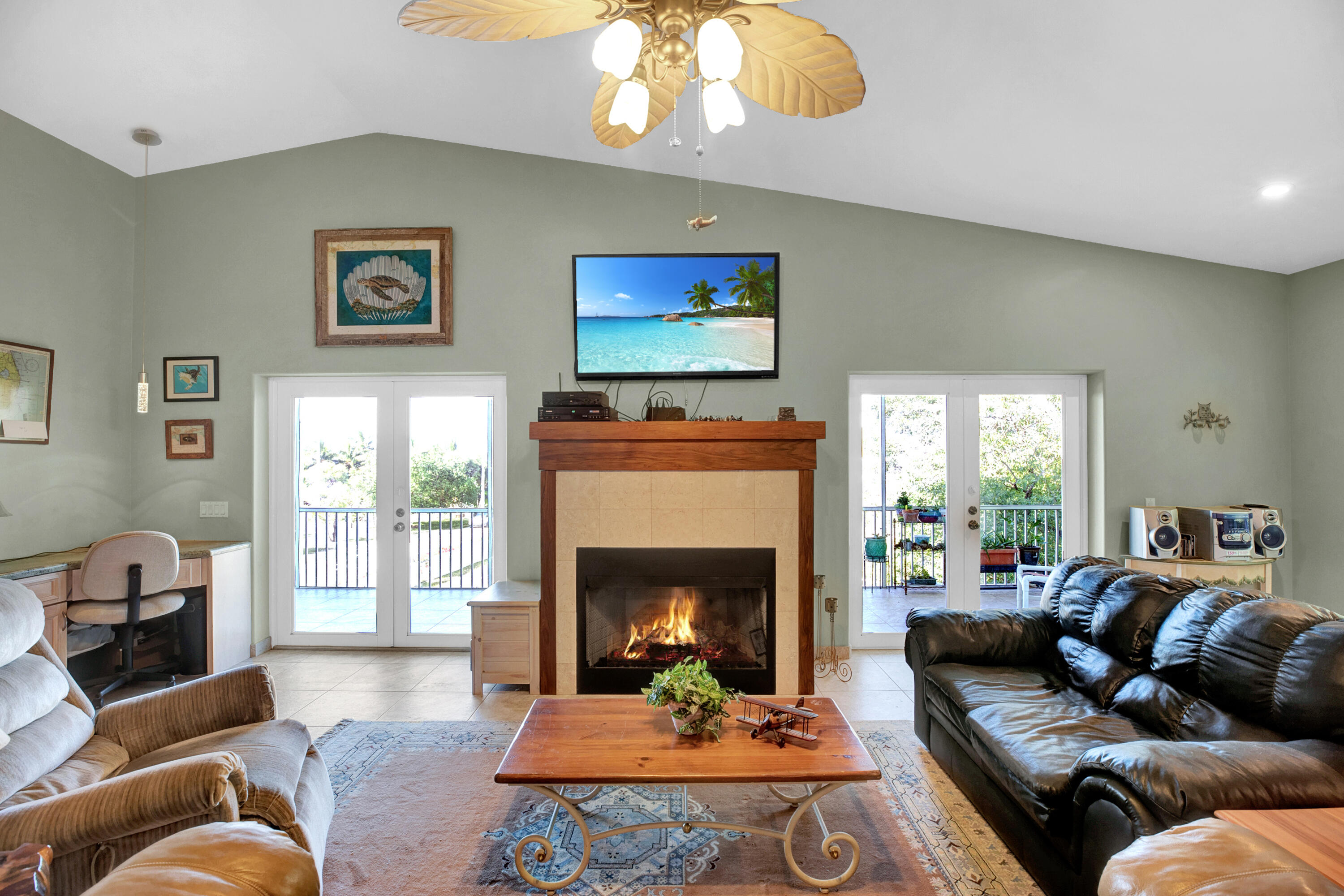 100 South Airport Road Tavernier, FL 33070 - Photo 10 of 42 a living room with furniture a window and a fireplace