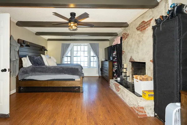 a spacious bedroom with a bed and a fireplace