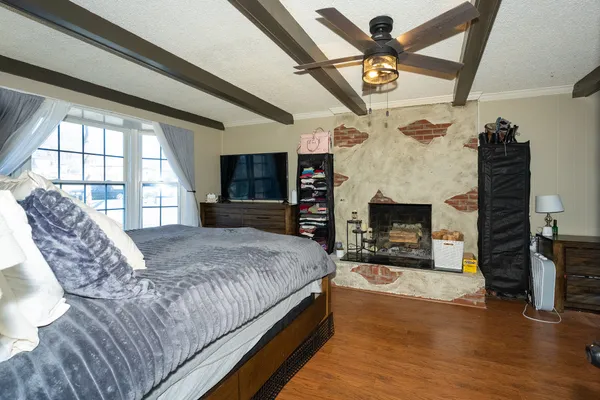 a living room with a couch wooden floor and a large window
