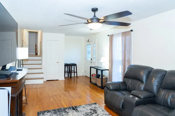 a living room with furniture and a wooden floor