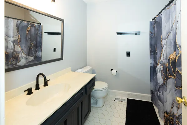a utility room with wooden floor washer and dryer