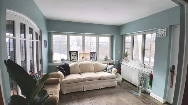 a view of a hallway with furniture and chandelier