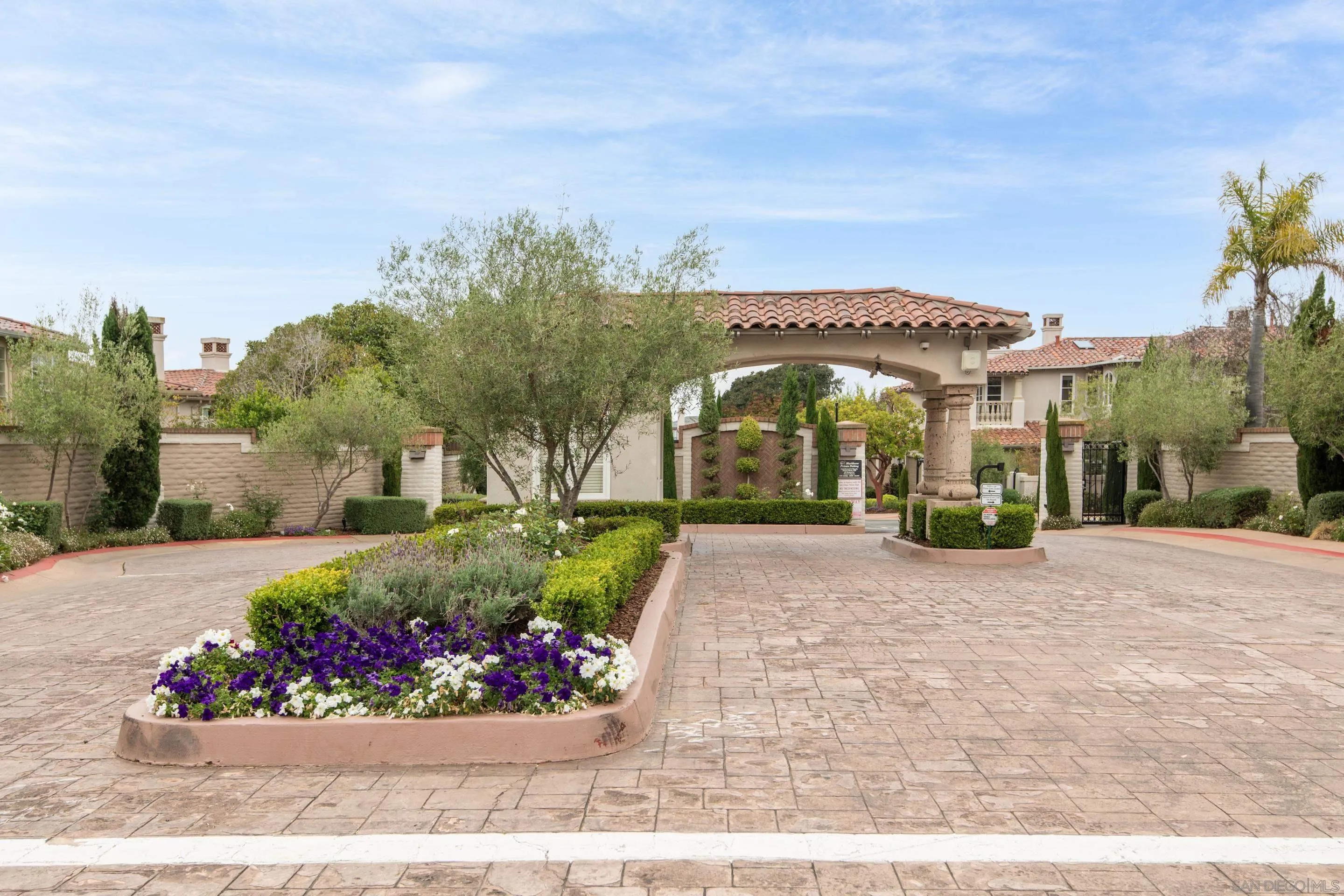 9767 Claiborne Square La Jolla, CA 92037 - Photo 2 of 50 a front view of a house with a garden