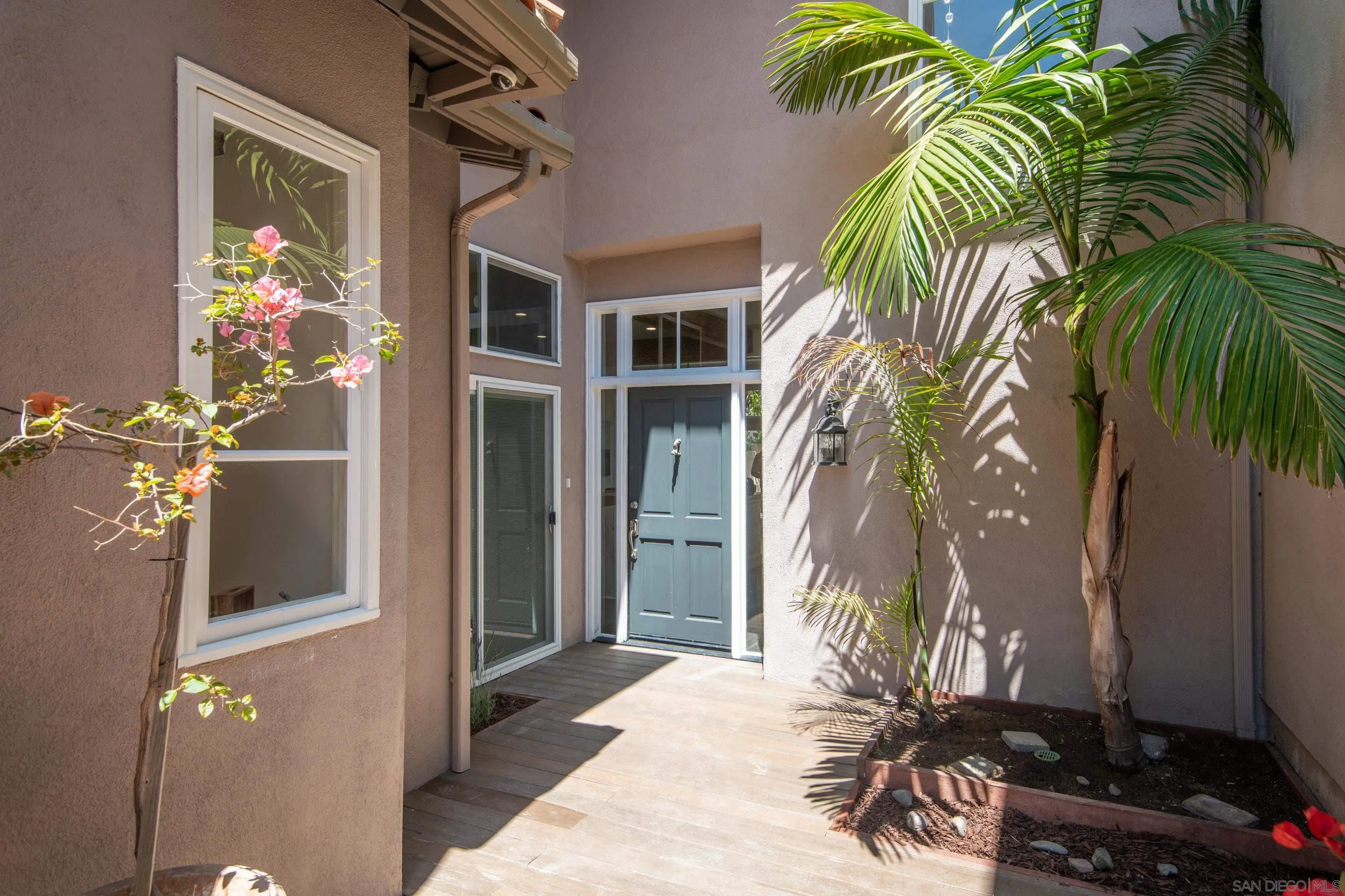 9767 Claiborne Square La Jolla, CA 92037 - Photo 5 of 50 a potted plant sitting in front of a house