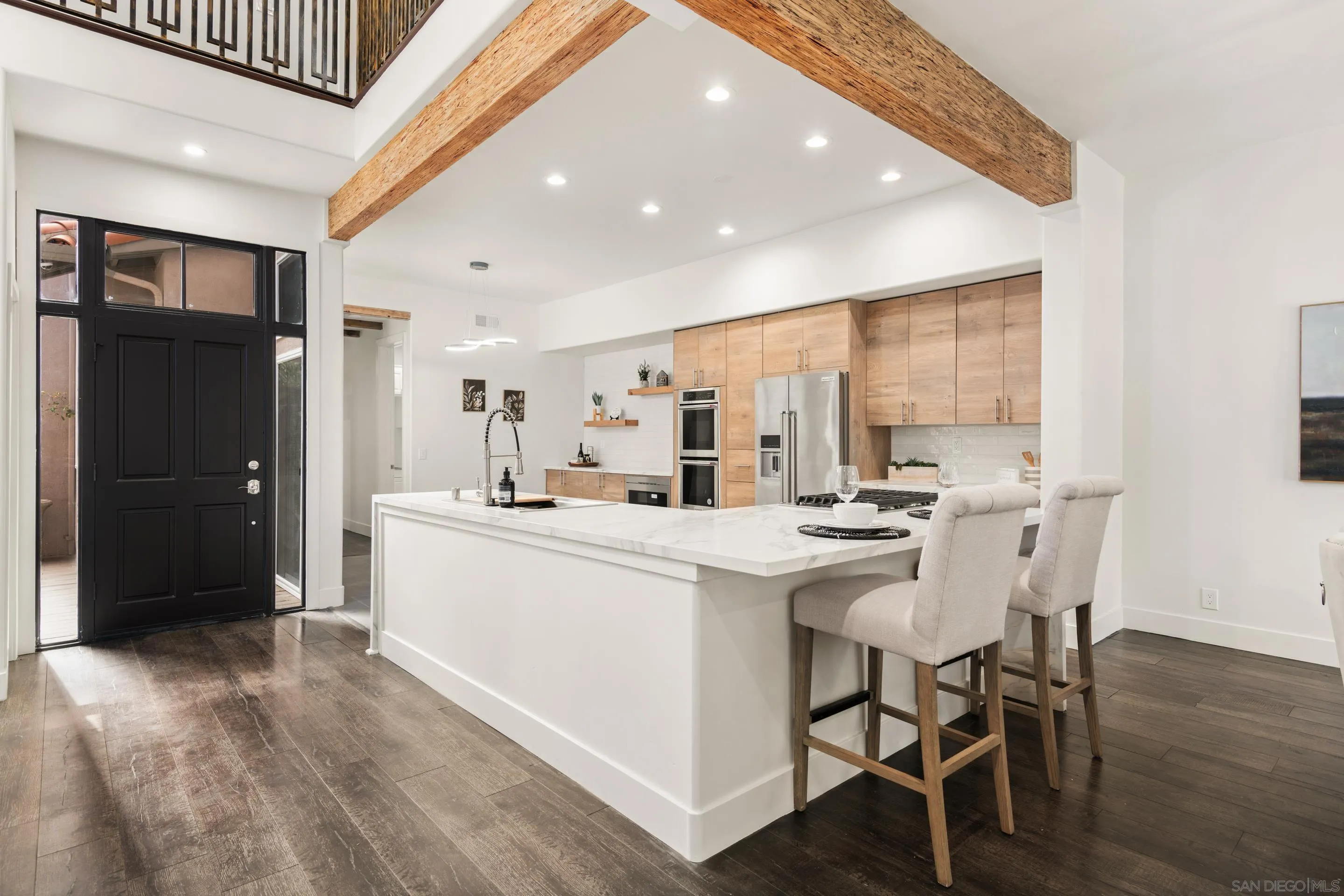 9767 Claiborne Square La Jolla, CA 92037 - Photo 8 of 50 a kitchen with a sink and chairs