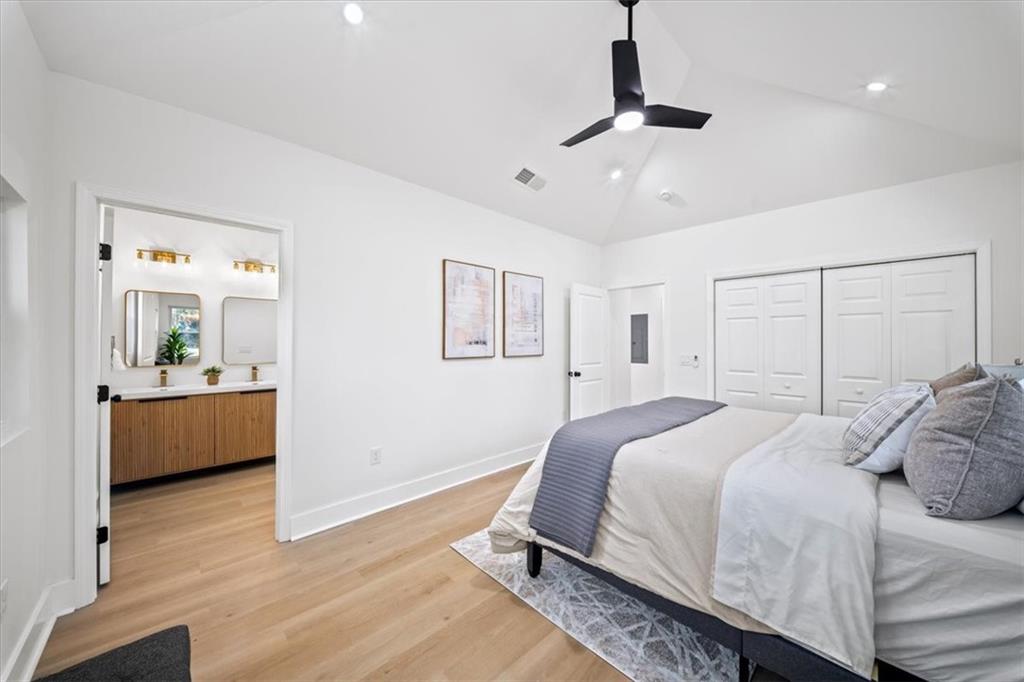 1523 Melrose Drive Southwest Atlanta, GA 30310 - Photo 14 of 33 a bedroom with a large bed and a chandelier