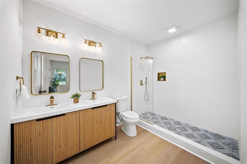 1523 Melrose Drive Southwest Atlanta, GA 30310 - Photo 16 of 33 a spacious bathroom with a double vanity sink toilet mirror and shower
