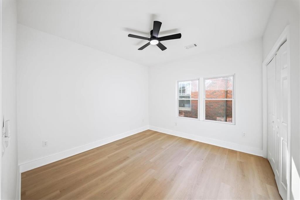 1523 Melrose Drive Southwest Atlanta, GA 30310 - Photo 17 of 33 a view of empty room with wooden floor and fan