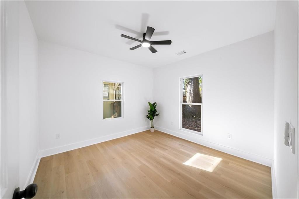 1523 Melrose Drive Southwest Atlanta, GA 30310 - Photo 20 of 33 a view of empty room with wooden floor and ceiling fan