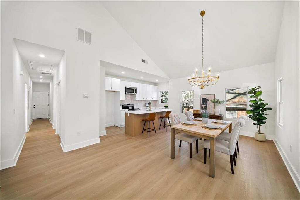 1523 Melrose Drive Southwest Atlanta, GA 30310 - Photo 7 of 33 a view of a dining room and livingroom with furniture wooden floor a chandelier