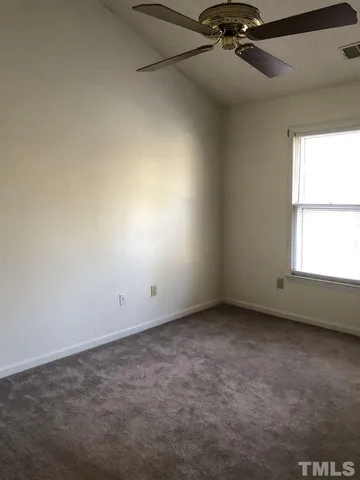 an empty room with a empty space and windows