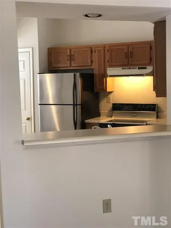 a view of kitchen with a refrigerator and window