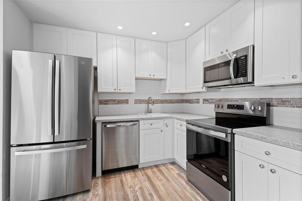 3801 42nd Street West Bradenton, FL 34205 - Photo 11 of 34 a kitchen with stainless steel appliances a refrigerator stove and microwave