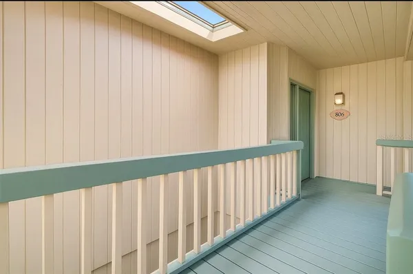 a view of a porch with wooden floor