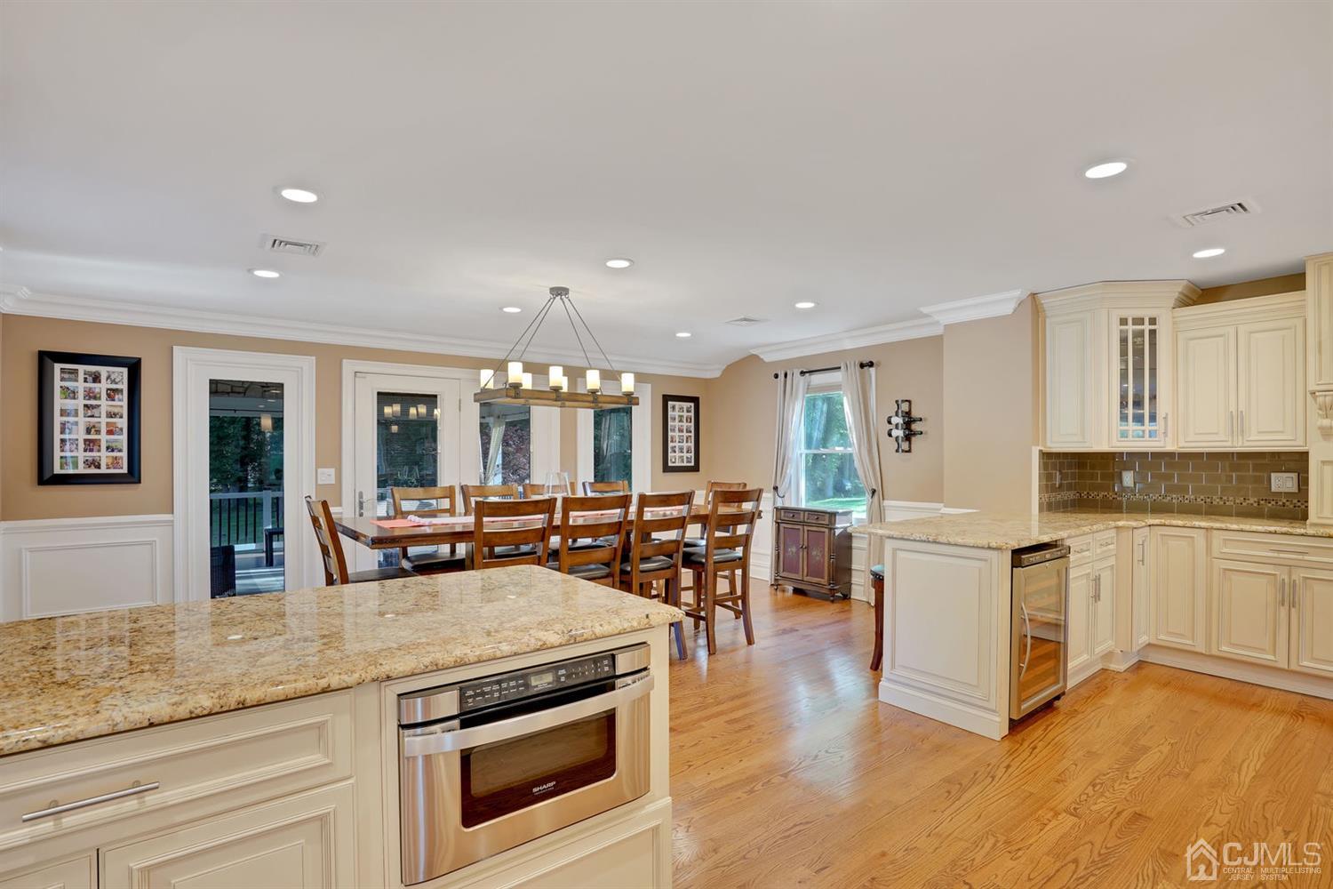 14 Fishel Road Edison, NJ 08820 - Photo 13 of 46 a kitchen with stainless steel appliances granite countertop a stove and white cabinets