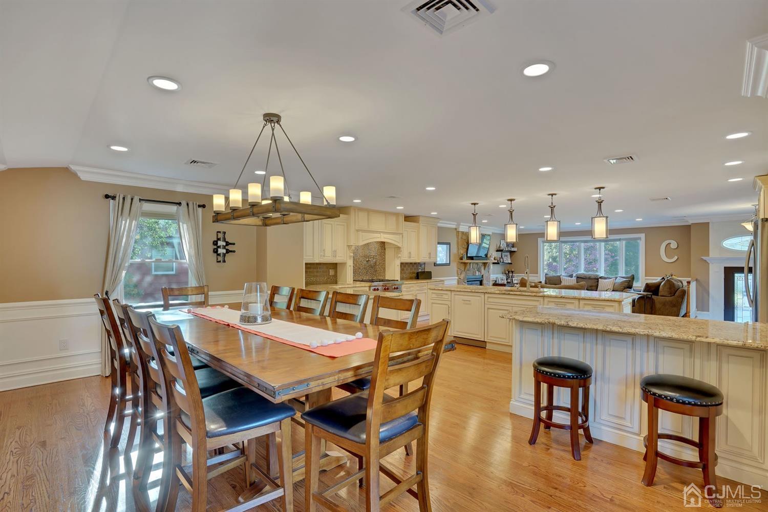 14 Fishel Road Edison, NJ 08820 - Photo 17 of 46 a dining area with a table chairs and a kitchen view