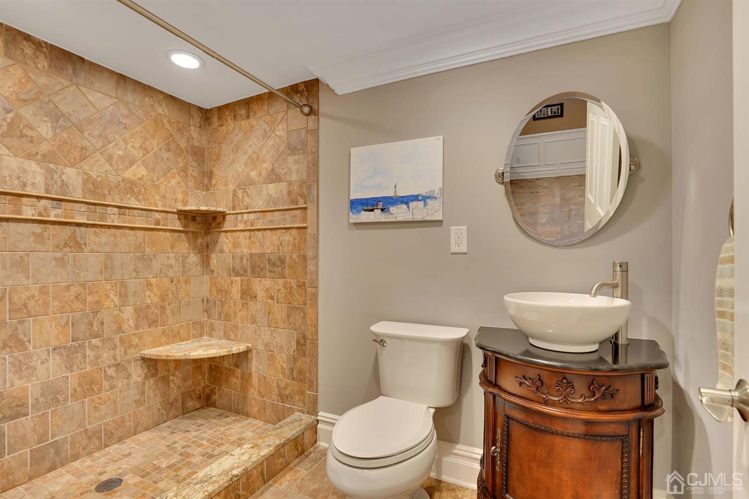 14 Fishel Road Edison, NJ 08820 - Photo 34 of 46 a bathroom with a toilet a sink and mirror