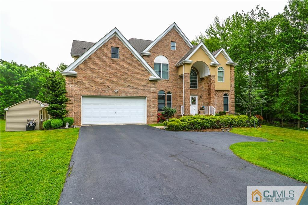 141 Westley Road Old Bridge, NJ 08857 - Photo 2 of 24 a front view of a house with a yard and garage