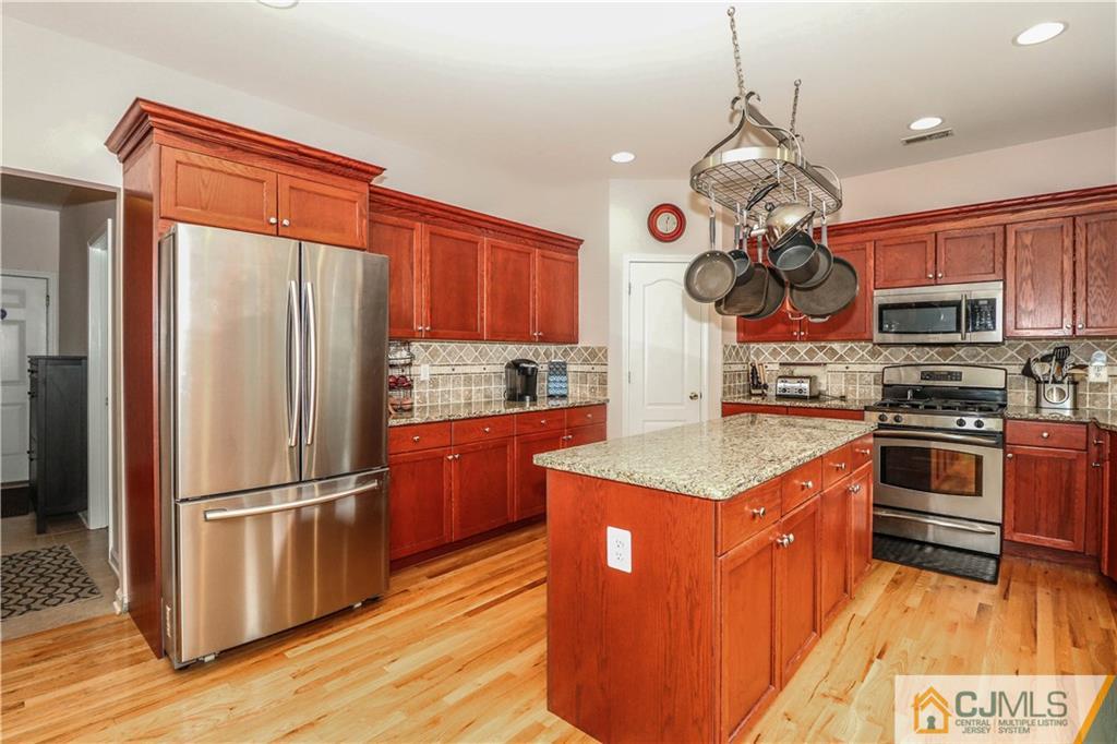 141 Westley Road Old Bridge, NJ 08857 - Photo 11 of 24 a kitchen with stainless steel appliances granite countertop a refrigerator a stove top oven a sink and dishwasher