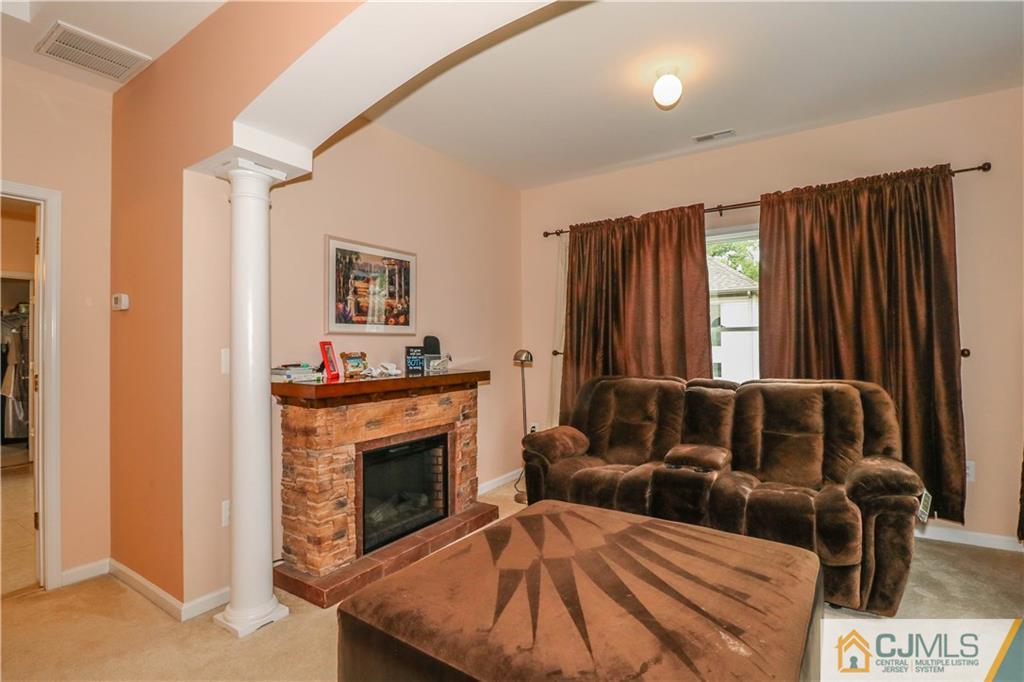 141 Westley Road Old Bridge, NJ 08857 - Photo 15 of 24 a living room with furniture and a fireplace