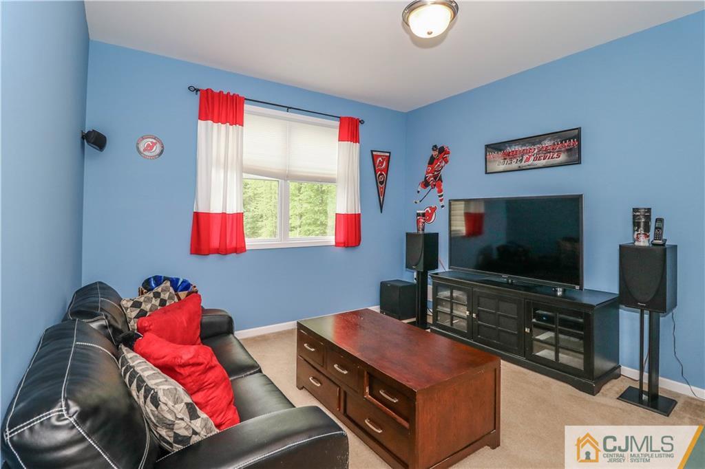 141 Westley Road Old Bridge, NJ 08857 - Photo 19 of 24 a living room with furniture and a flat screen tv