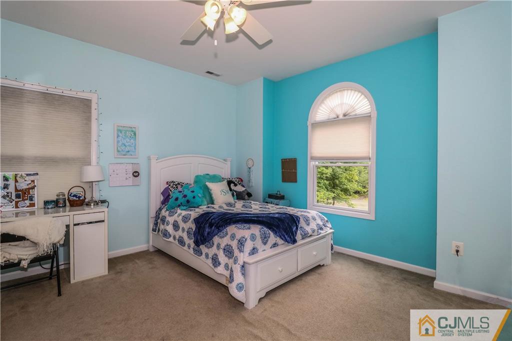 141 Westley Road Old Bridge, NJ 08857 - Photo 20 of 24 a bedroom with a bed and a chandelier