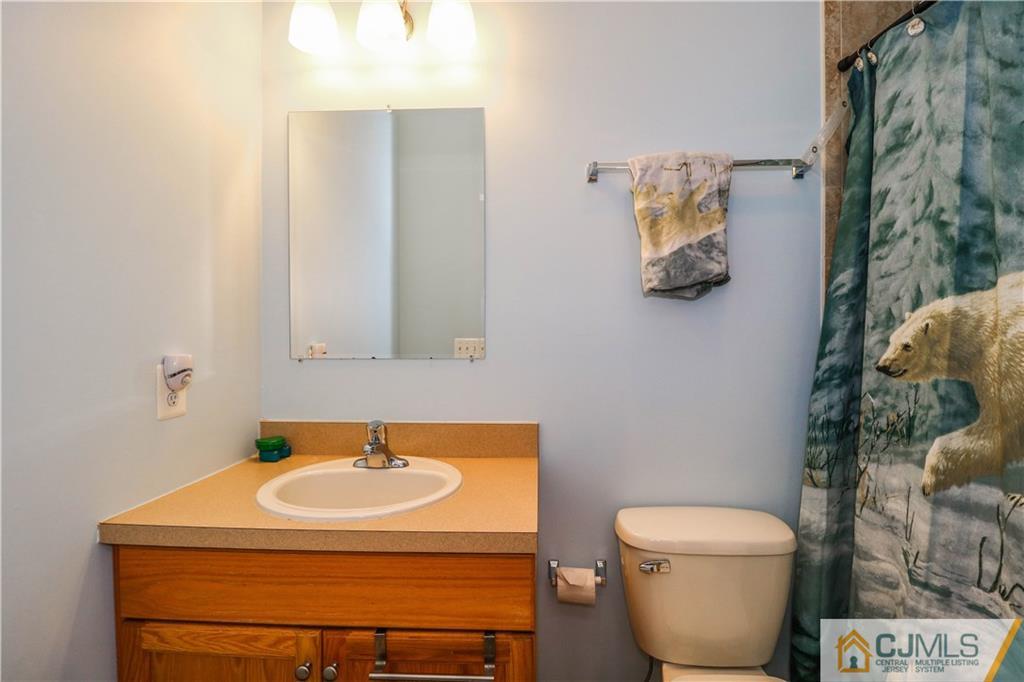 141 Westley Road Old Bridge, NJ 08857 - Photo 21 of 24 a bathroom with a sink and a toilet