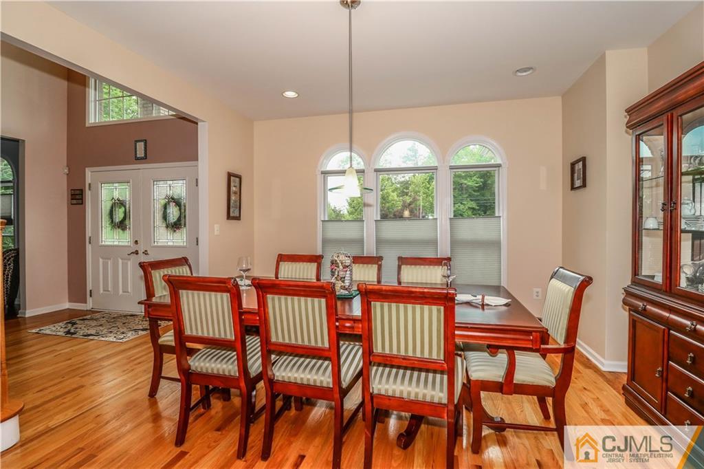141 Westley Road Old Bridge, NJ 08857 - Photo 5 of 24 a view of a dining room with furniture wooden floor and a chandelier