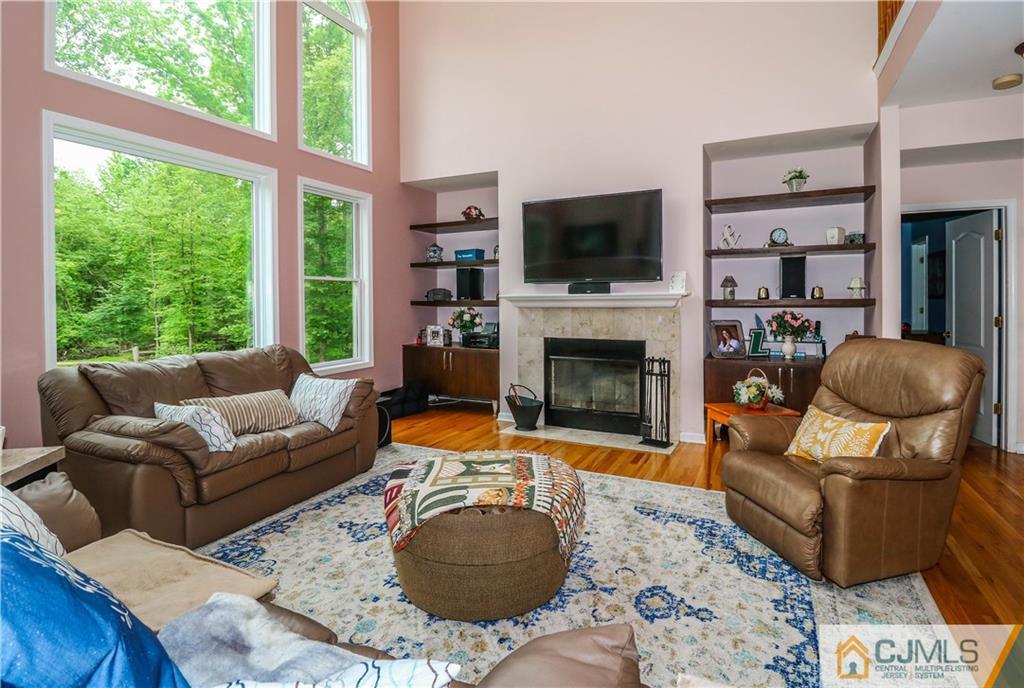 141 Westley Road Old Bridge, NJ 08857 - Photo 7 of 24 a living room with furniture a flat screen tv and a fireplace