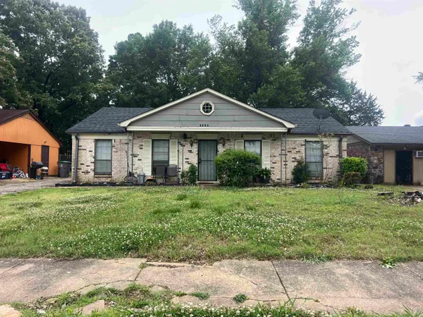 a front view of a house with a yard and porch